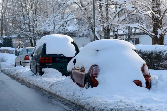 Cars covered in snow